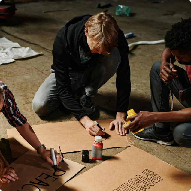 about page hero image protestors creating signs