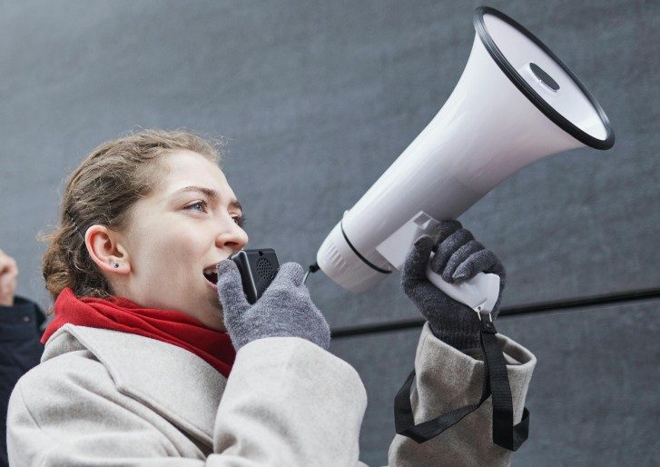 woman protesting with megaphone